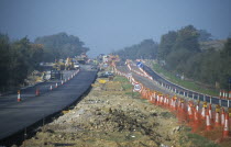 View along the A21 lined with traffic cones and new tarmac road surface