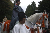 Grand procession of Toshogu shrine  1 000 man samurai procession  man in costume of Edo era high official  on horseback being lead by others in costume.