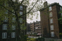 Greenwich council housing with trees and public garden.