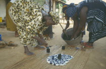 Women working together to produce indigo tie dye fabric.