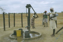 Women collecting water from hand pump.