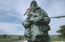 Royal Marines Museum. Large statue of a Royal Marine holding a gun displayed at Main entrance with a Union Jack flag fyling behind
