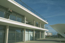 De La Warr Pavilion. Exterior view of visitors on balcony terrace and corner of bandstand. Art Deco building built by the Earl Of De La Warr in 1935 Designed by Erich Mendelsohn and Serge Chermayeff...