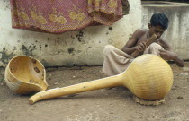 Instrument maker finishing a veena  a traditional stringed instrument consisting of a hollow wooden body and long neck.  Thanjavur