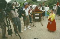 Filming period drama.  Director  cameraman and actors.