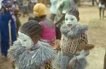 Young girls attending initiation ceremony with white painted faces.
