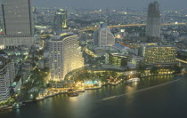 Aerial view of the Skyline. Large Hotel with swimming pool and boats next to the Chaophraya River