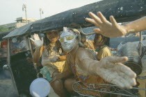 People in a tuk tuk covered in mud  celebrating the Songkhran Festival. Thai New Year  15 April.