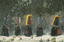Men in costume for the Fiesta de San Juan in northern region near Mount Cayambe.