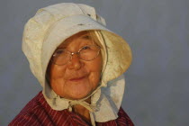 Head and shoulders portrait of elderly Seventy two year old woman called Fumiko Sase working in a rice field