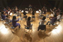 United Freedom Orchestra rehearsing for spring concert Junior and senior high school students  13 to 18 years old  top center is conductor and music teacher Satoshi Miyano