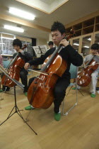 Teenage high school boy playing the cello for United Freedom OrchestraAkimitsu Suzuki  18 year old high school 3rd year