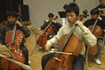 United Freedom Orchestra Cello section. Teenage boys performing on stage.Akimitsu Suzuki  18 years od  MR 8  front right  Kazuto Sawawatari  18 years old  MR 4front left  Kohei Unazawa  17 years old...