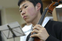 Teenage boy playing cello for United Freedom Orchestra  Akimitsu Suzuki  18 years old  3rd year high school boy