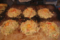 Narita Gion Festival. Okonomiyaki cabbage pancakes being grilled.