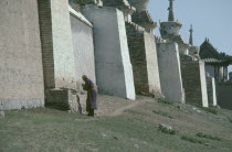 Pilgrim circumnavigating city walls on site of ancient capital of Ghengis Khan.