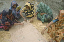 Women drawing a map of village as part of community development project.
