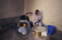 Woman cooking injera  a type of sour  flat bread that accompanies most meals.