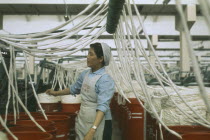 Woman working in cotton factory.