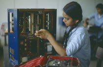 Woman working in electronics factory. Mumbai