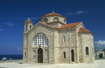 Agios Georgiou church exterior with tiled roof and bell tower.