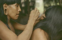 Auca Indians grooming.Waorani