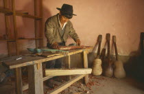 Charango musical instrument maker at workbench.Sucre Chuquisaca