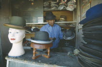El Alto.  Hat maker in La Ceja making traditional brown and grey bowler hats known locally as a bombin.Gray