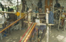 Weaver at hand loom prodcungin traditional multi coloured Kente clothAsante Colored