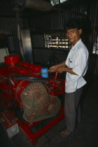 Mechanic maintaining diesel generator.