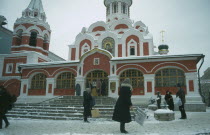 Red Square.  Pedestrians clearing a path through the snow.