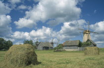 Farm buildings haystack and windmill