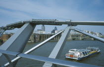 Section of the Millennium footbridge with passing tour boat