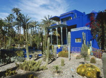 Jardin Majorelle. Vibrant blue building surrounded by a garden of palm trees and cactus plants.Marrakesh Marrakech