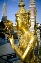 Or Royal Palace. Golden temple statue of a figure holding a flower