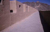 The Great Wall. View along the path and crenellated wall leading toward hillside