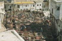 Chouras tanneries. View over workers and large dye vats.