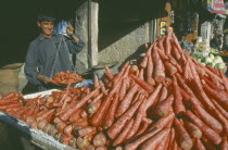 Carrot vendor holding scales