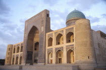 Mir I Arab Madrassah Mosque facade and dome seen in evening light