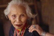 Portrait of an elderly Karen Refugee woman with a younger womans hand on her shoulder