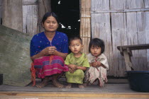 Karen refugee mother and two children squat outside house
