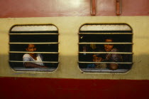 Passengers at barred train windows
