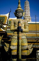 Or Grand Palace. Elaborate statue with tower behind