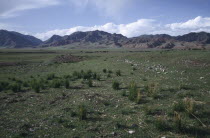 Grassland arealeading toward hills on the horizon