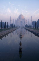 Taj Mahal reflected over misty pool at Dawn