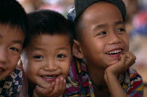 Portrait of three smiling Karen refugee boys