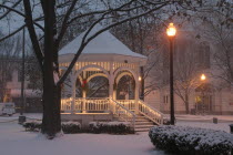 Gazebo or band stand in early morning snowstorm  Christmas Decorations  lampposts.  winter  winter
