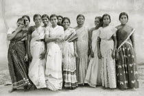 Female workers at St. Josephs Orphanage smile and laugh for the camera.  Black and white image.