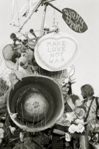The Rinky Dink and peace protesters during an anti-war rally at RAF Fairford. Make love not war poster.Black and white image.