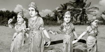 Statues torn away from a nearby Hindu temple by the Indian Ocean Tsunami are relocated onto the beach by local villagers in order to ward off further destruction.statuesgodsgoddessesbrokensmashed...